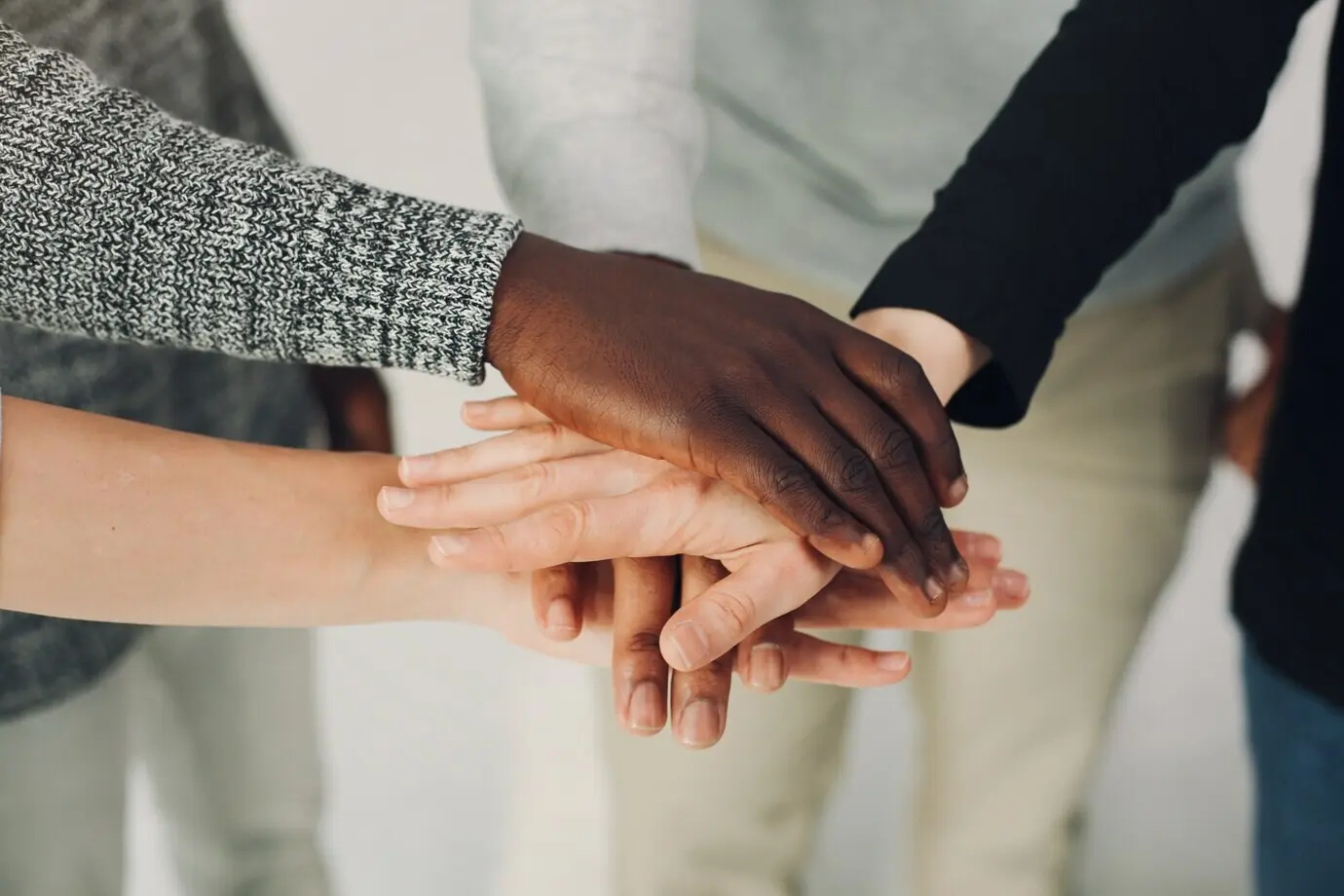 Junge internationale Personen arbeiten gemeinsam und verwenden einen Laptop.